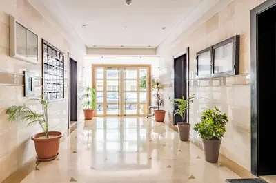 a hallway with potted plants in a building at Layover Guest House Apartment & parking Rabat Agdal City Center in Rabat