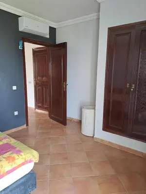 a room with a bed and some wooden cabinets at Villa de rêves in Casablanca
