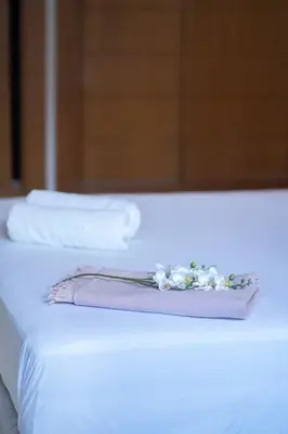 a white bed with two white pillows and a mirror at Hot location flat at Maarif bd Anfa near Ahmet chef in Casablanca