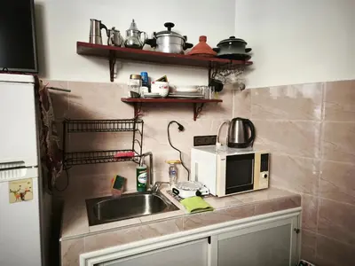 a kitchen with a sink and a microwave at Garden Beet in Sidi Rahal