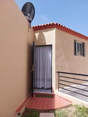 a door to a house with a gate at Garden Beet in Sidi Rahal