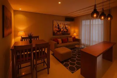 a living room with a couch and a table at Superbe Appartement avec piscine et jacuzzi privé in Casablanca