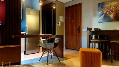 a living room with a table and a bar at Superbe Appartement avec piscine et jacuzzi privé in Casablanca