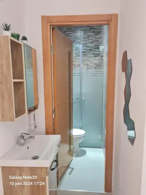 a bathroom with a shower and a sink and a toilet at Chez Najib et Ziad in Temara