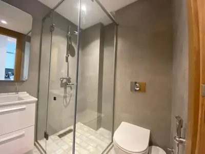 a bathroom with a shower with a toilet and a sink at CORNICHE CASABLANCA - SUBLIME F2 NEUF in Casablanca