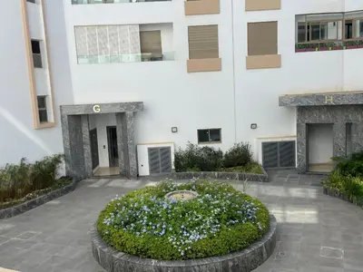 a large building with a circular garden in front of it at CORNICHE CASABLANCA - VINTAGE F2 NEUF in Casablanca