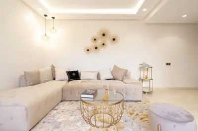 a living room with a couch and a table at Luxury one bedroom in Maarif one in Casablanca