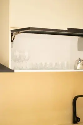 a white cabinet with a shelf in a kitchen at Luxury one bedroom in Maarif one in Casablanca