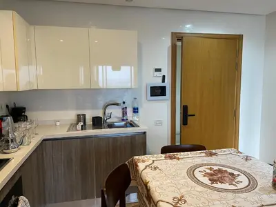 a small kitchen with a table and a sink at Superb Apartment on 14th floor with Jacuzzi in Casablanca