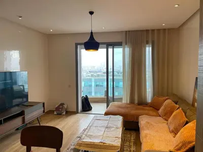 a living room with a couch and a flat screen tv at Superb Apartment on 14th floor with Jacuzzi in Casablanca