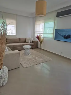 a living room with a couch and a table at My Cosy Place Rabat - Cosy Home Wifak Temara in Temara