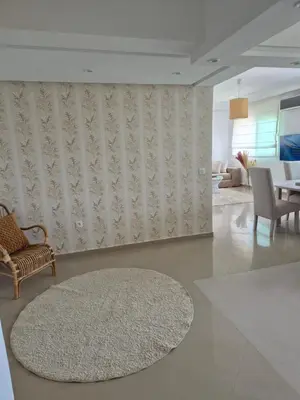 a living room with a table and a rug at My Cosy Place Rabat - Cosy Home Wifak Temara in Temara