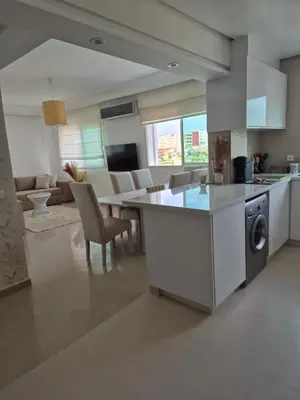 a kitchen and living room with a table and chairs at My Cosy Place Rabat - Cosy Home Wifak Temara in Temara