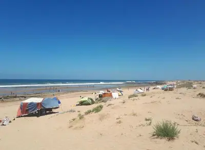 a group of tents on a beach near the ocean at Mohammédia Marbella beach appartement familliale in Mansouria