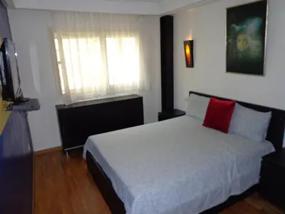 a bedroom with a white bed with a red pillow at Zen Home in Casablanca