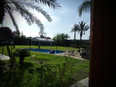 a view of a swimming pool from a yard at Jnane Ville Verte in Casablanca