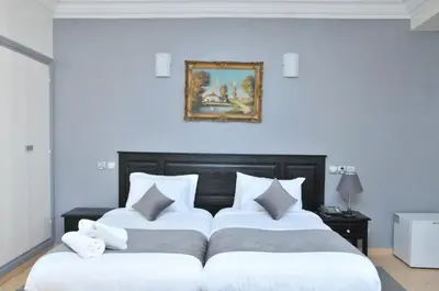 two beds in a bedroom with a picture on the wall at EAST WEST HOTEL in Casablanca