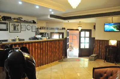 a living room with a bar and a tv at EAST WEST HOTEL in Casablanca