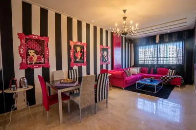 a living room with a red couch and a table at Chez Betty in Casablanca