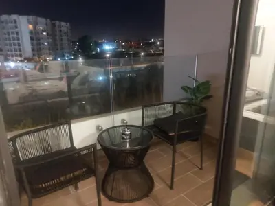 a balcony with a table and chairs and a window at Chez Betty in Casablanca