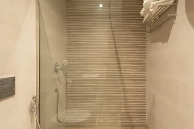 a shower with a glass door in a bathroom at Chez Betty in Casablanca
