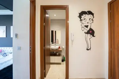 a bathroom with a mural of a woman brushing her teeth at Chez Betty in Casablanca