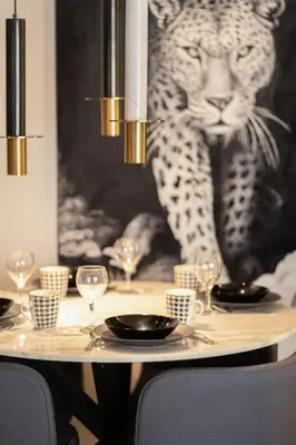 a table with wine glasses and a picture of a leopard at Metropolitan 06-Two Bedrooms - Cavalli Luxury Flat in Casablanca