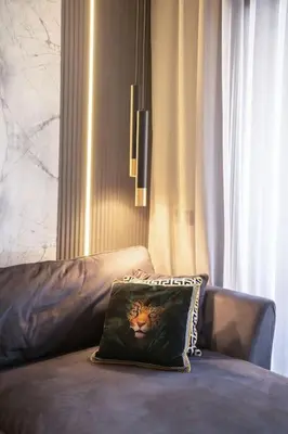 a pillow sitting on top of a leather couch at Metropolitan 06-Two Bedrooms - Cavalli Luxury Flat in Casablanca