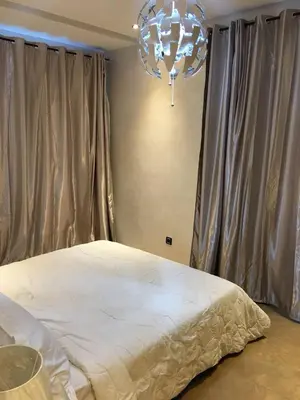 a bedroom with a bed and a chandelier at Nice Apartment For Families- Bd Ghandi- Casablanca in Casablanca