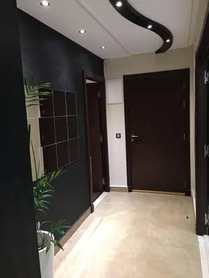 a hallway with black walls and a plant at Nice Apartment For Families- Bd Ghandi- Casablanca in Casablanca