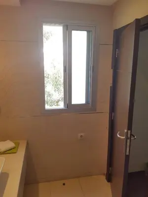 a bathroom with a window and a sink and a door at Nice Apartment For Families- Bd Ghandi- Casablanca in Casablanca