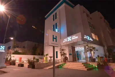 a building with a sign in front of it at night at Nice Apartment For Families- Bd Ghandi- Casablanca in Casablanca