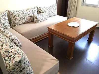 a living room with a couch and a wooden table at Nice Apartment For Families- Bd Ghandi- Casablanca in Casablanca