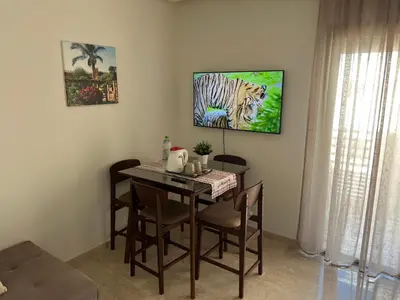 a dining room table with a painting of a tiger at TAJ NOUACEUR AéROPORT MOHAMMED V in Nouaceur