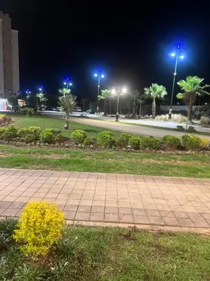 a park at night with a sidewalk and street lights at TAJ NOUACEUR AéROPORT MOHAMMED V in Nouaceur
