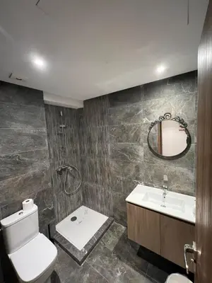 a bathroom with a toilet and a sink and a mirror at TAJ NOUACEUR AéROPORT MOHAMMED V in Nouaceur