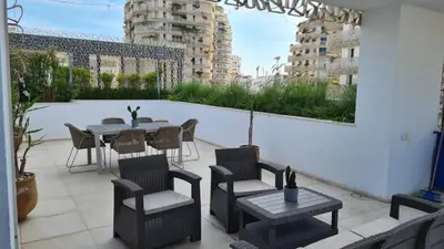 a patio with a table and chairs on a balcony at Duplex Rooftop d'exception terrasse panoramique de 100 m2 in Casablanca