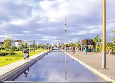 a fountain in a park with people walking around it at A 2 minutes de Casa Finance City, appartement avec 2 Chambres in Casablanca