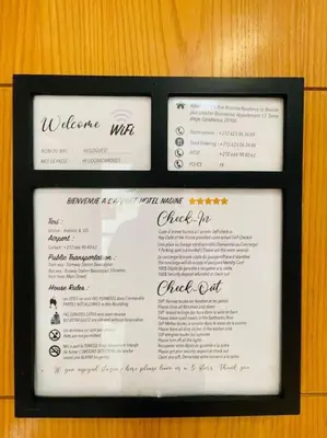 a menu for a restaurant on a wooden table at A 2 minutes de Casa Finance City, appartement avec 2 Chambres in Casablanca
