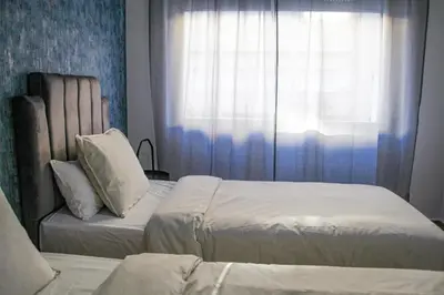 a bedroom with two beds and a window at YourPlace - 2BR - Agdal - Av France in Rabat
