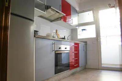 a kitchen with a stainless steel refrigerator and red cabinets at YourPlace - 2BR - Agdal - Av France in Rabat