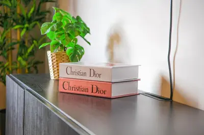 a stack of books sitting on top of a table at YourPlace - 2BR - Agdal - Av France in Rabat