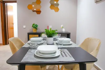 a dining room table with white plates and silverware at YourPlace - 2BR - Agdal - Av France in Rabat
