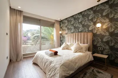 a bedroom with a large bed with a window at New upscale central maarif flat in Casablanca