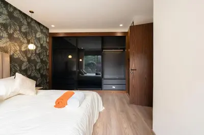 a bedroom with a bed with an orange towel on it at New upscale central maarif flat in Casablanca