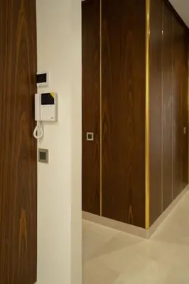 a room with a wooden door and a wall at New upscale central maarif flat in Casablanca