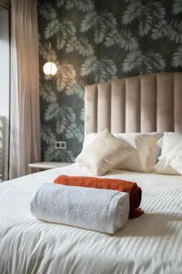 a bed with two towels sitting on top of it at New upscale central maarif flat in Casablanca