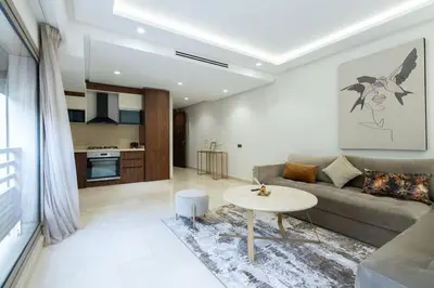a living room with a couch and a table at New upscale central maarif flat in Casablanca