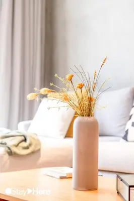 a vase with flowers sitting on a table at Stayhere Casablanca - Gauthier 1 - Modern Residence in Casablanca