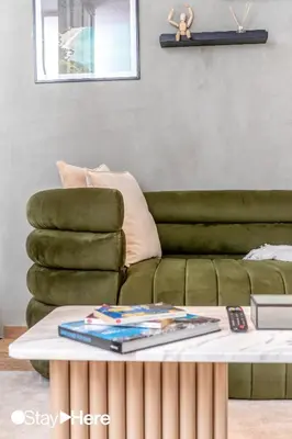 a living room with a green couch and a coffee table at Stayhere Casablanca - Gauthier 1 - Modern Residence in Casablanca